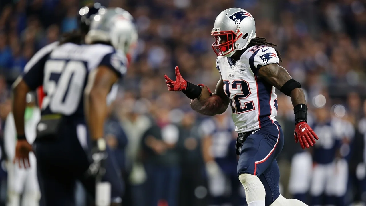A tight sideline action frame of a wide receiver adjusting to a deep ball at the catch point, captured with a shallow depth of field.